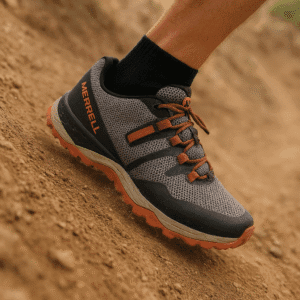 photo of man in zero drop hiking shoe takinmg a step down a steep hill