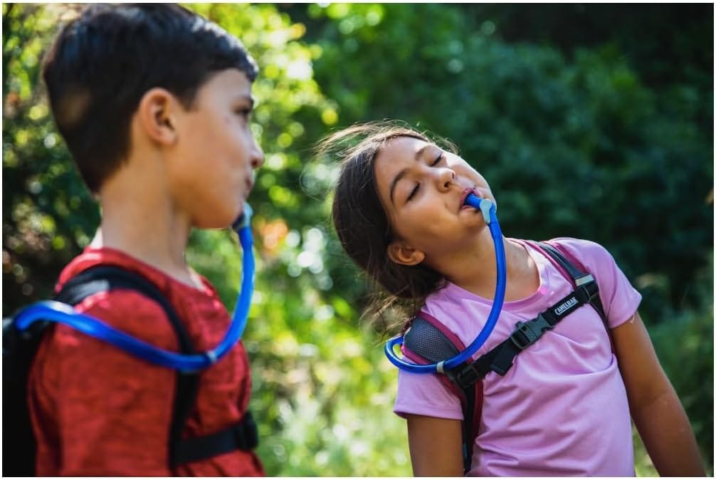 Children exploring nature with hydration packs.